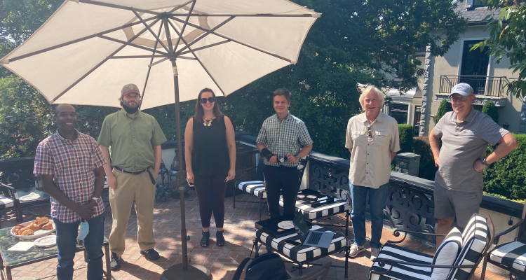 The entire team at Gerard's house on his patio outside: Delwin, Scott, Stephanie, Lewis, Paul, and Gerard